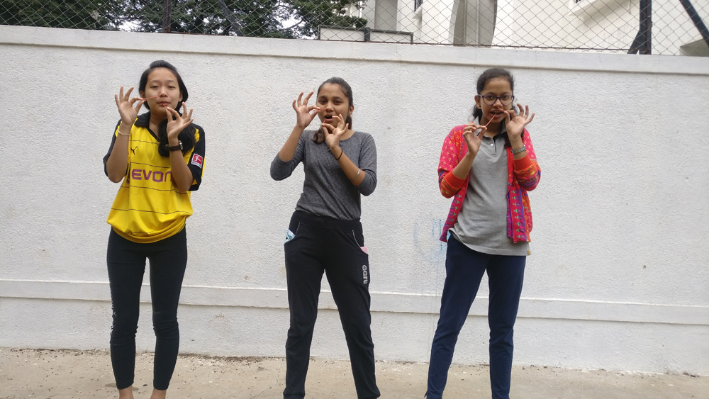 college girls while doing practice of yoga competition- (Sutra neti Kriya) at college.