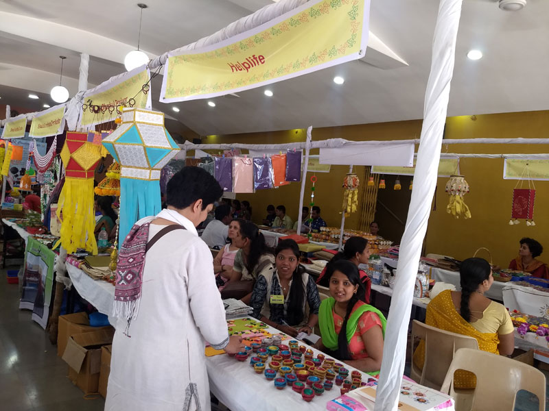 Students and Helplife boarders enthusiastically selling products at Srujan - II